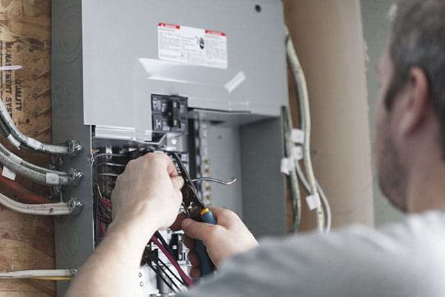 Electrician upgrading a service panel