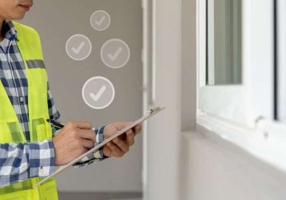 inspector or engineer is inspecting construction and quality assurance new house using a checklist. Engineers or architects or contactor work to build the house before handing it over to the homeowner