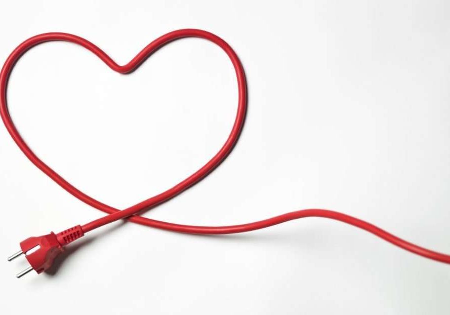 Heartshaped red cable on white background