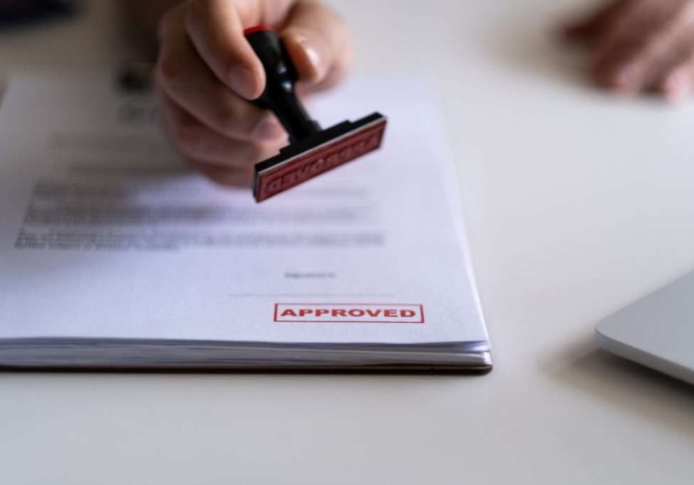 Lending concept. Pre-approved mortgage loan. Business Man Stamping With Approved Stamp On Document. Business approve Stamp and certificate concept. Businessman Hands Stamping a document
